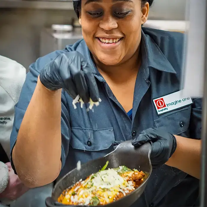 rule prime pasta chef in kitchen closeup focused on preparing dish with fresh ingredients candid moment hickory nc