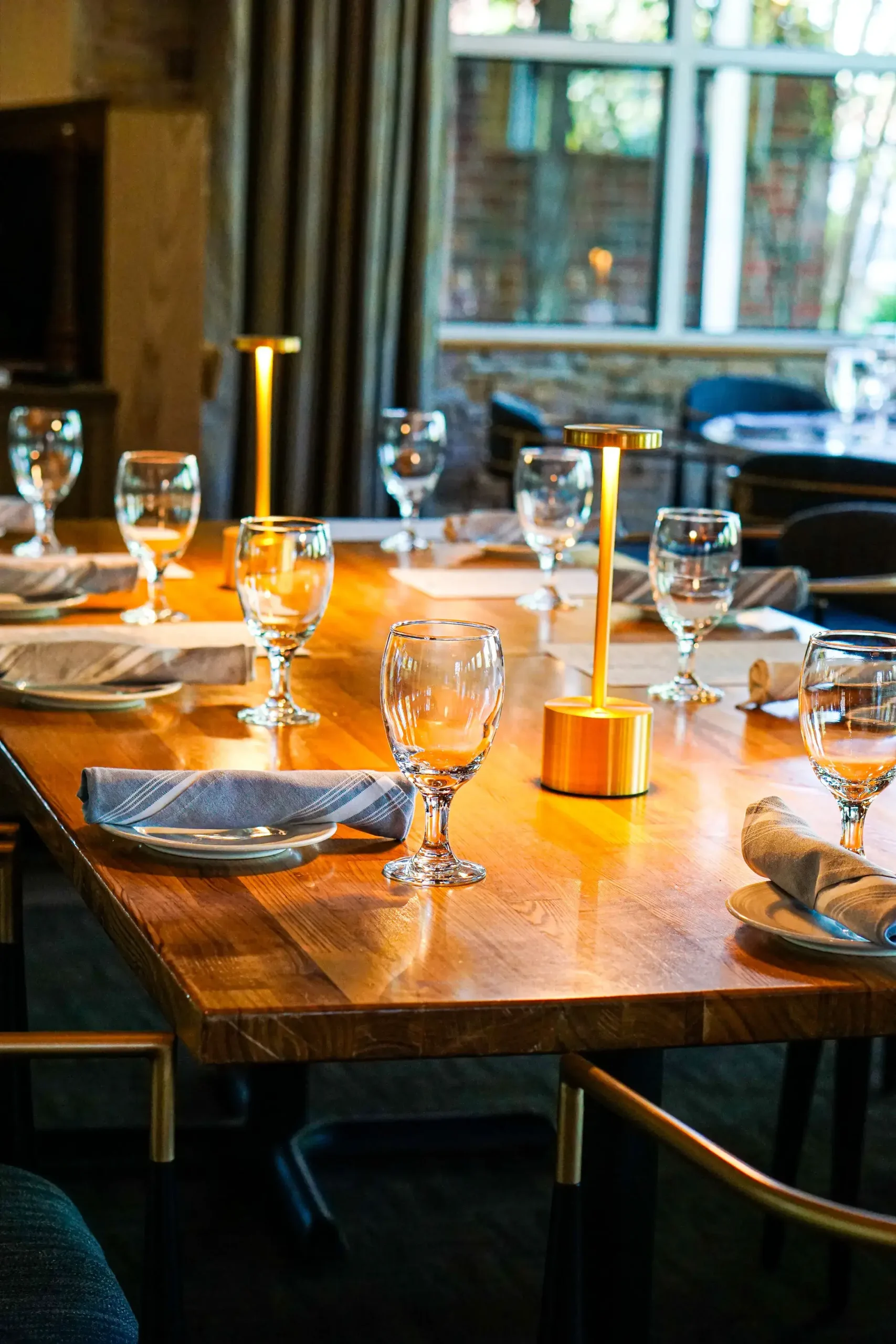 rule prime pasta dining table closeup with golden lamp glassware soft lighting warm atmosphere hickory nc