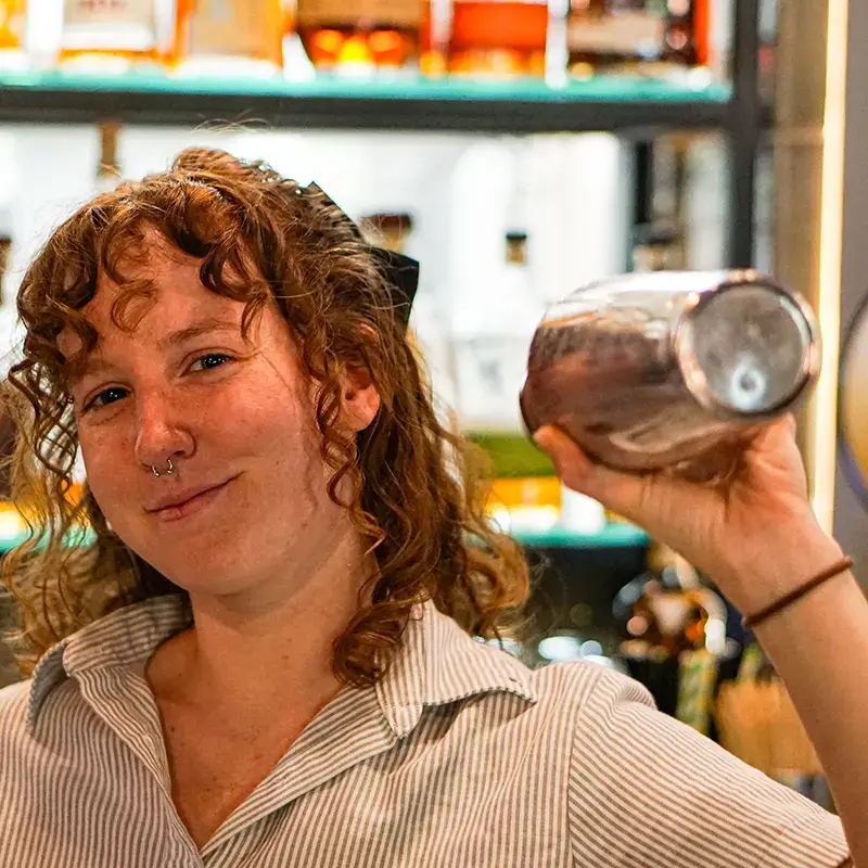 rule prime pasta happy smiling bartender mixing drinks in warm bar setting striped shirt candid closeup hickory nc