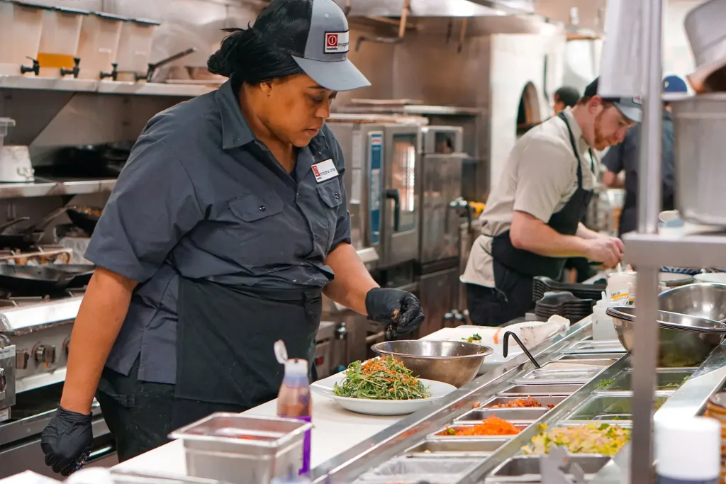 rule prime pasta kitchen team preparing food in professional culinary space with industrial equipment and countertops h