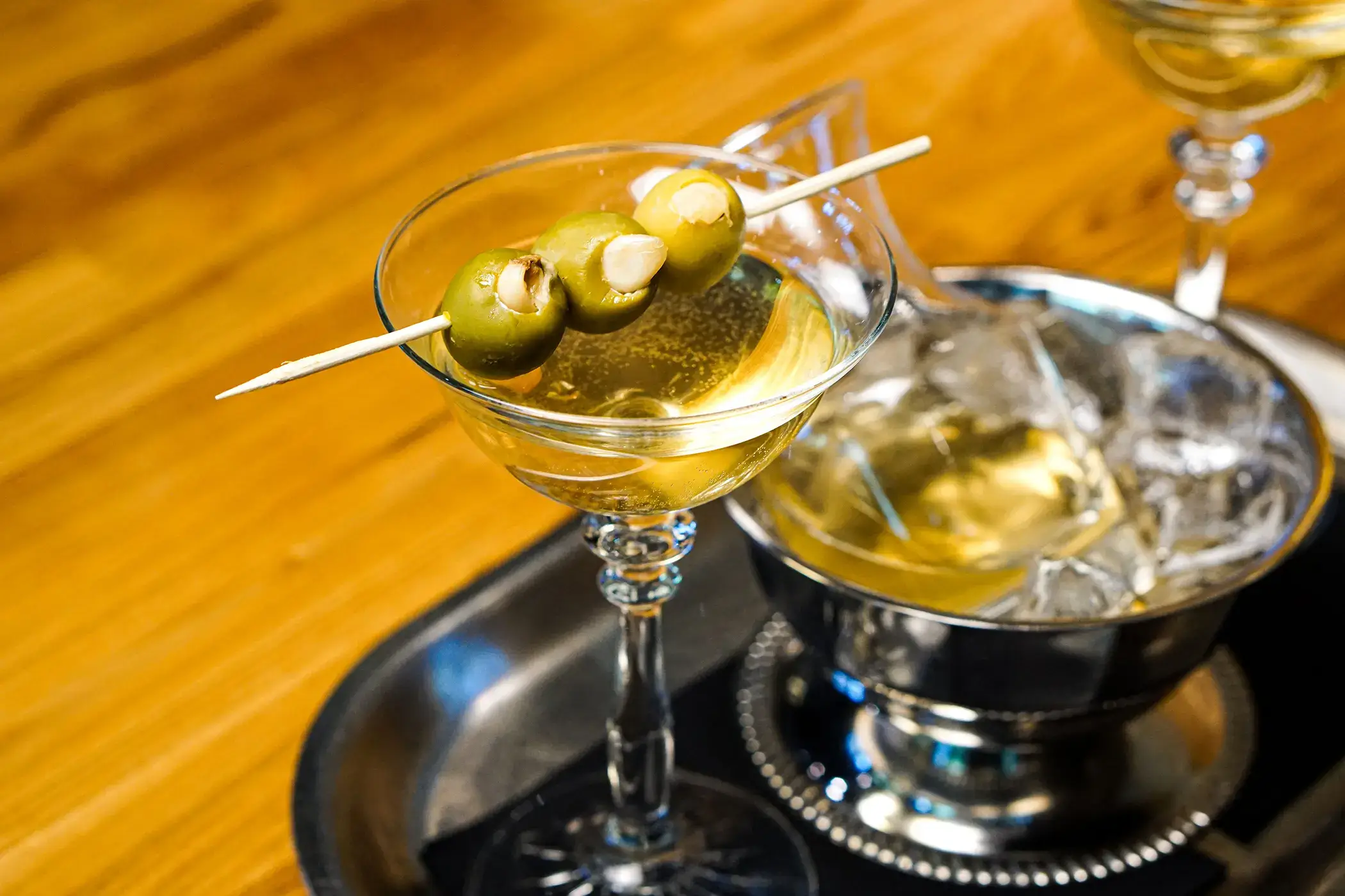 rule prime pasta martini glass cocktail closeup with pickled garnish on rustic surface stylish drink presentation hicko